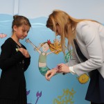 Princess Beatrice is presented with a gift by one of the children